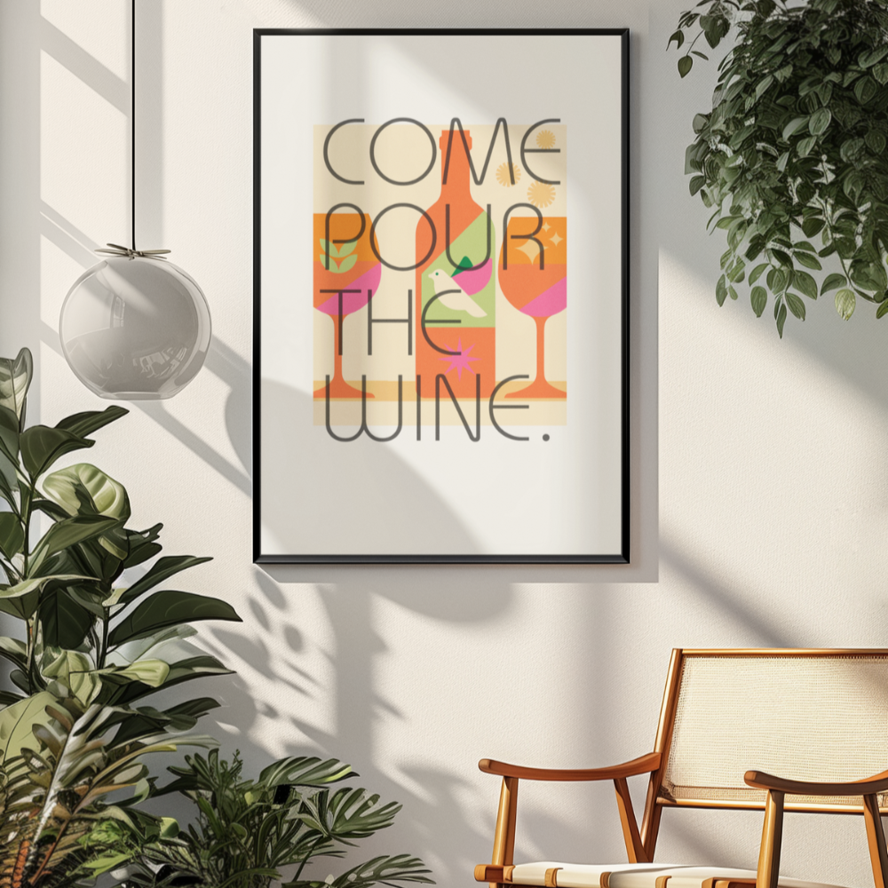 Framed artwork with 'Come pour the wine' text in a modern room with plants and a chair.