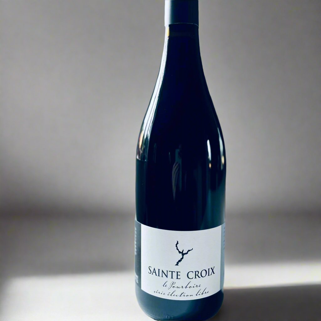 A close-up image of a bottle of Domaine Sainte Croix Pourboire wine, featuring a minimalist label design with blue and white tones, set against a softly blurred background. This is a red biodynamic wine known for its organic production and vibrant flavour profile.