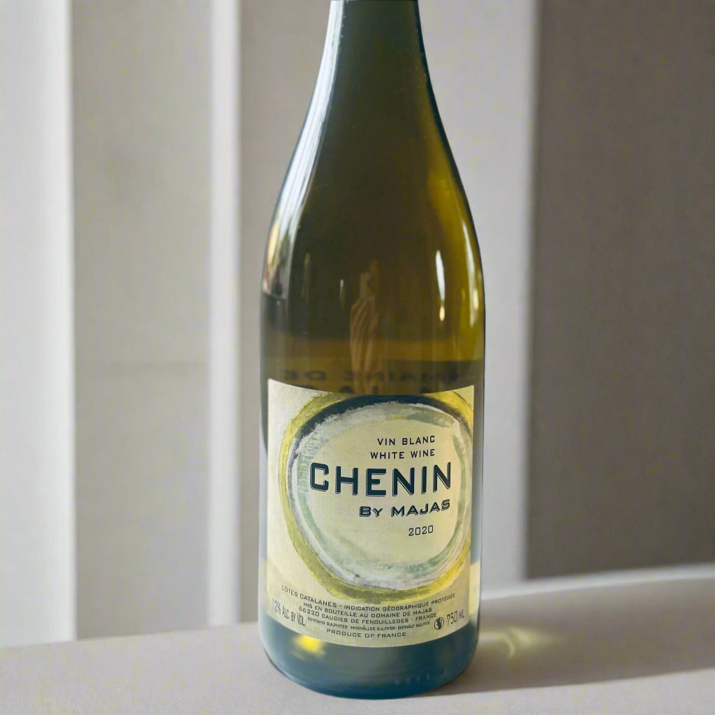 A bottle of Domaine de Majas Chenin Blanc 2020 organic white wine, featuring a minimalist label design, photographed on a clean white background.