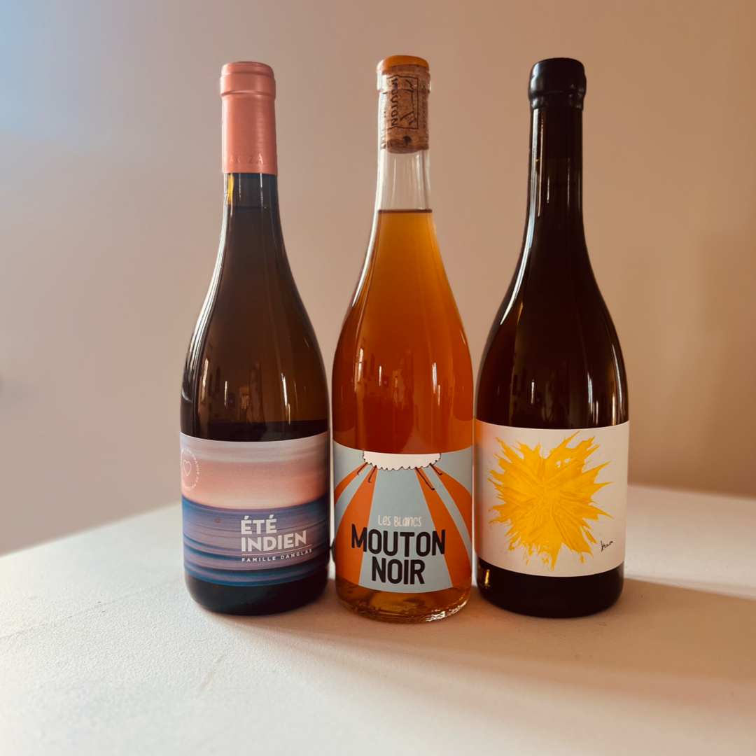 Three bottles of orange wine from Taste Union: Été Indien, Mouton Noir, and Giles Troullier Maceration. Unique selection of orange wines showcasing rich amber hues.