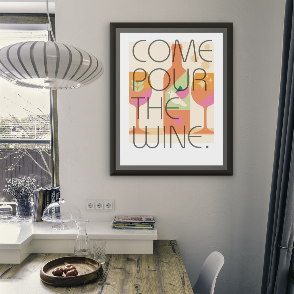 Modern interior with a dining table and 'Pour the Wine' framed print on the wall.