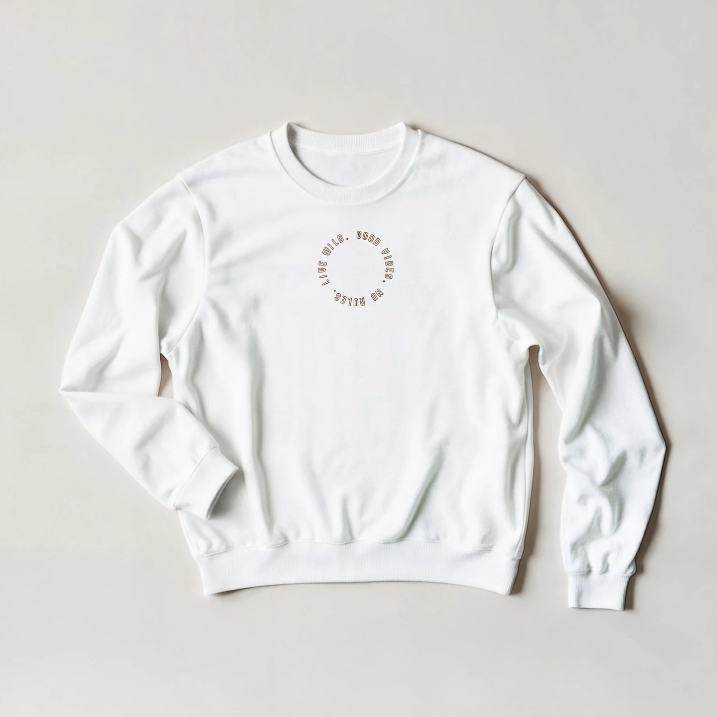 White embroidered sweatshirt with gold stitched text reading ‘Good Vibes, No Rules, Live Wild’ – unisex oversized fit sustainable gift by Taste Union.