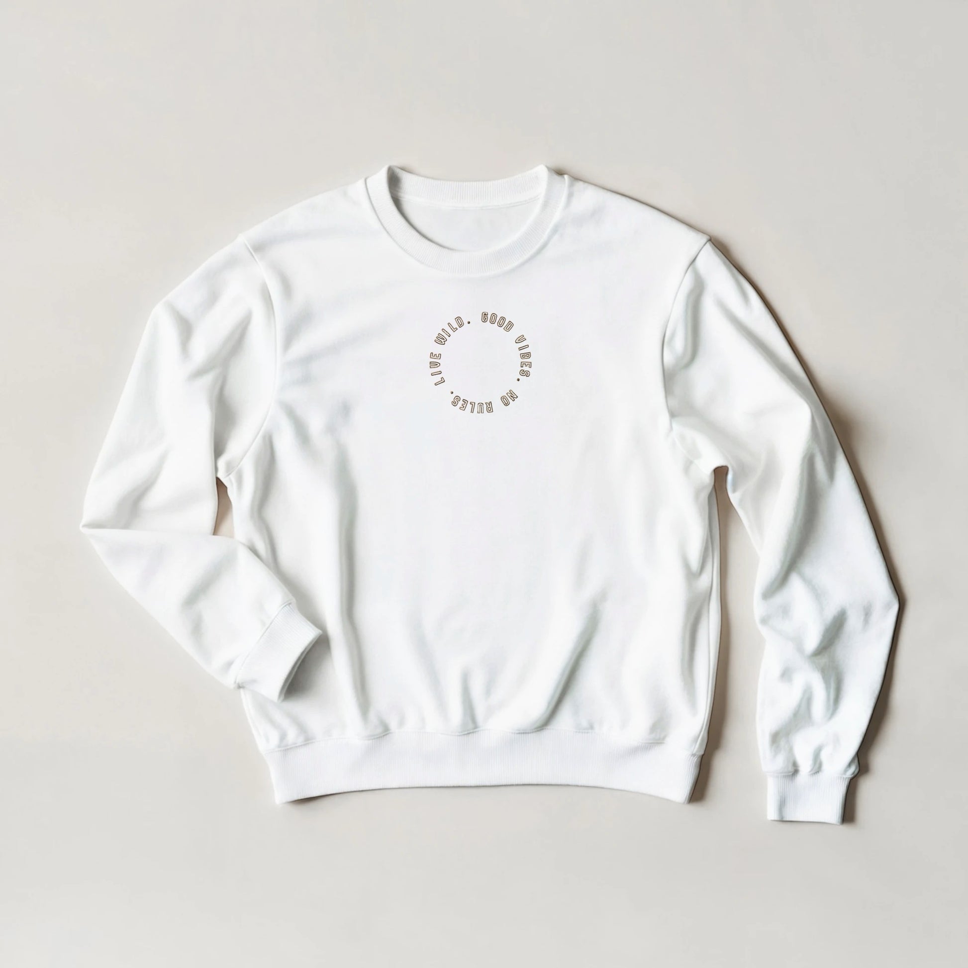 White embroidered sweatshirt with gold stitched text reading ‘Good Vibes, No Rules, Live Wild’ – unisex oversized fit sustainable gift by Taste Union.
