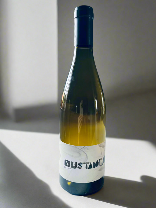 A bottle of La Nouvelle Don(n)e Mustango 2021 white wine. The label features minimalist typography, and the bottle is displayed on a clean white background with soft lighting.