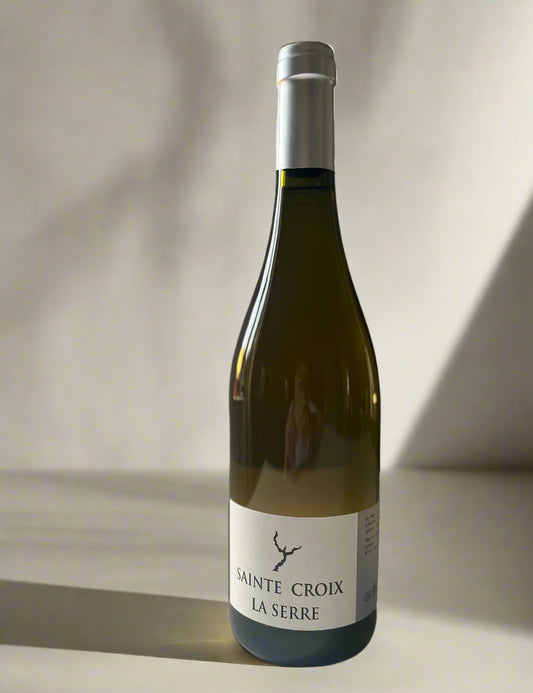 Bottle of Domaine Sainte Croix La Serre 2022 white wine on a white surface, with a minimalist label design featuring the wine’s name and logo.