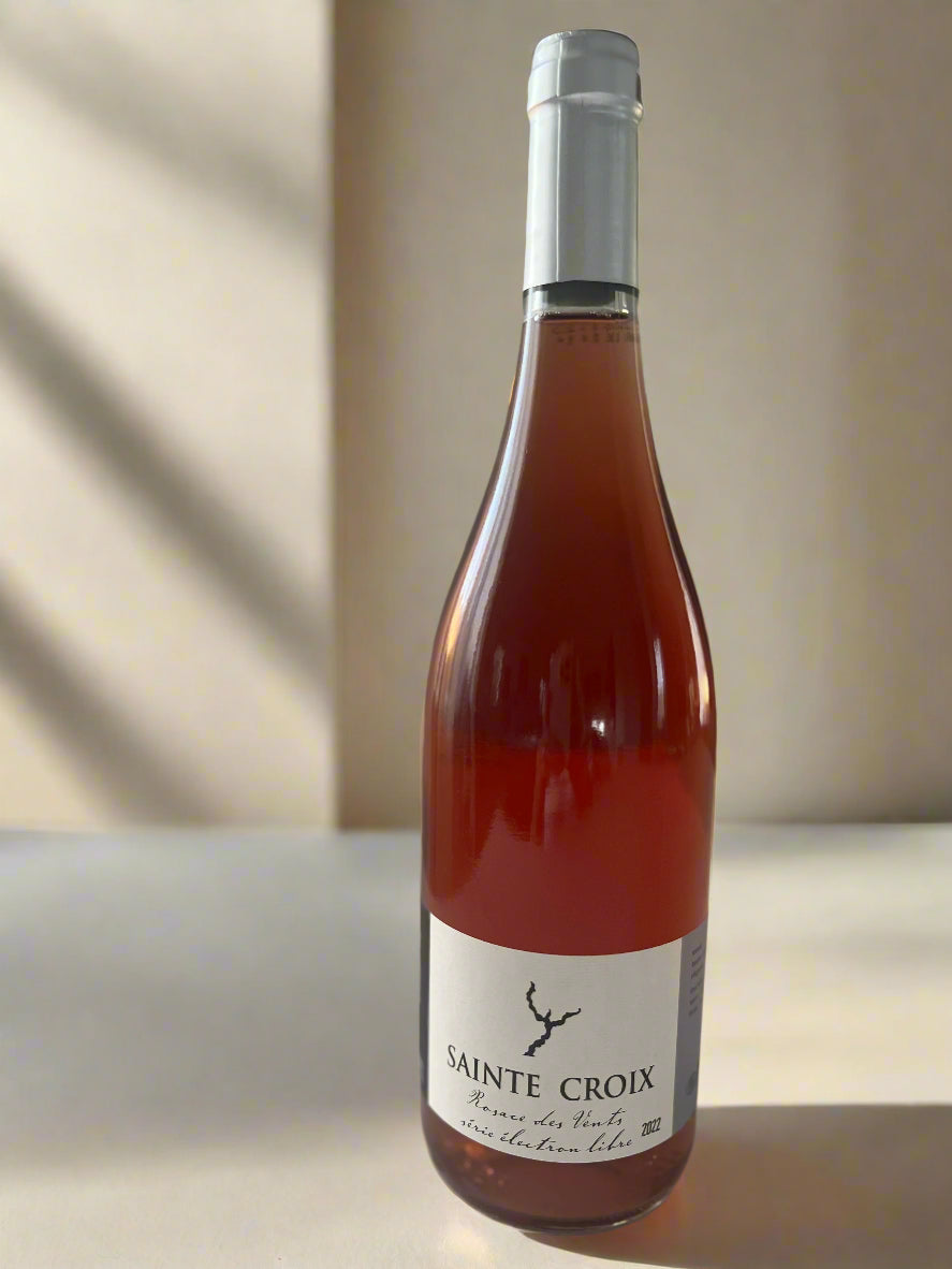 A bottle of Domaine Sainte Croix Rosace des Vents 2019 Rosé Wine. The bottle features a vibrant pink hue and a minimalist label, placed on a neutral background.