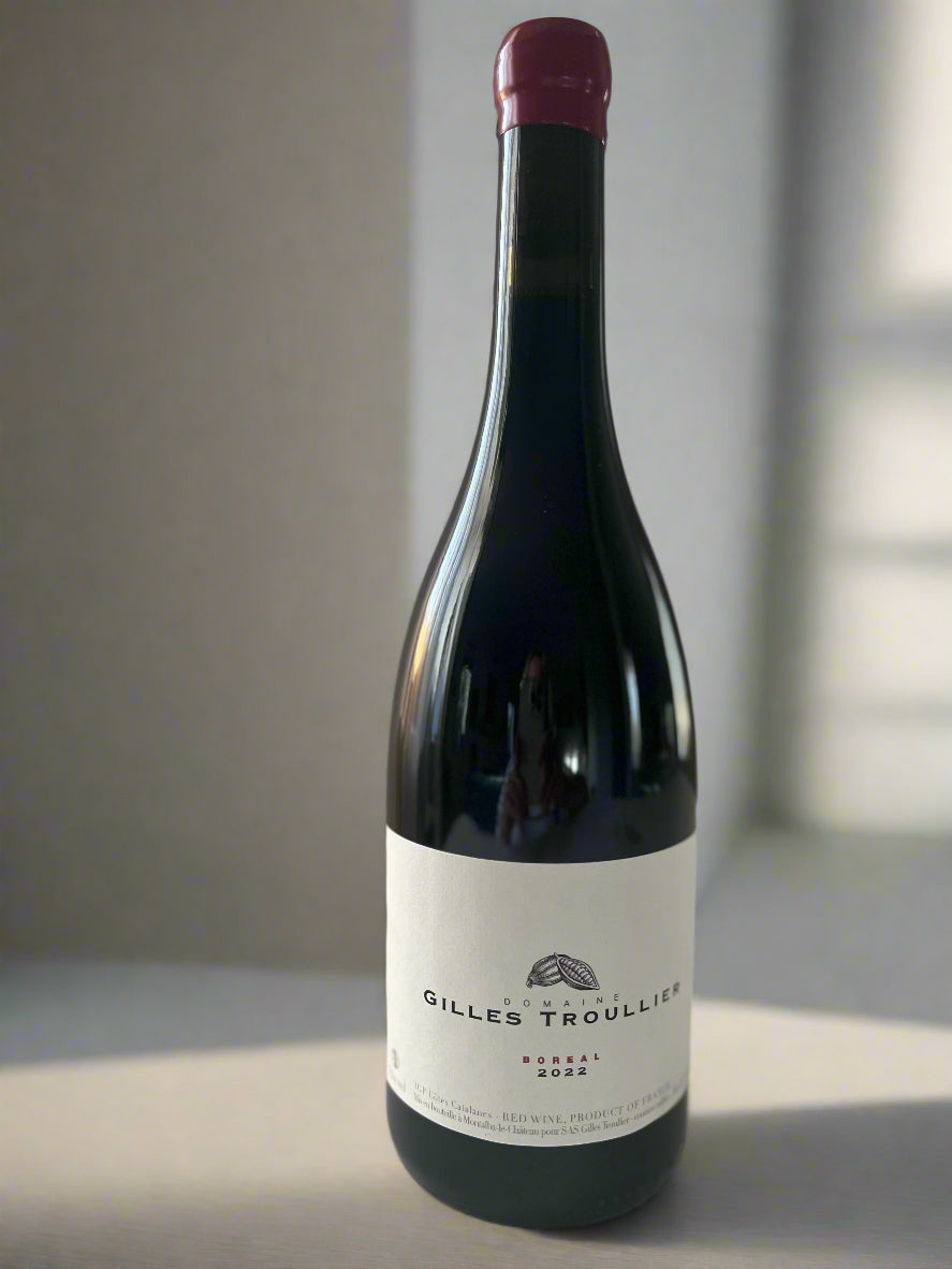 A bottle of Gilles Troullier Boreal 2022 Syrah with a cork and wax seal, showcasing the minimalist label design on a neutral background.