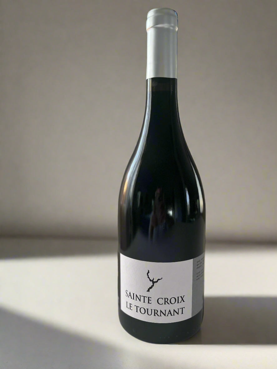 Bottle of Domaine Sainte Croix Le Tournant 2019 Syrah wine, featuring a minimalist label, placed on a neutral background.