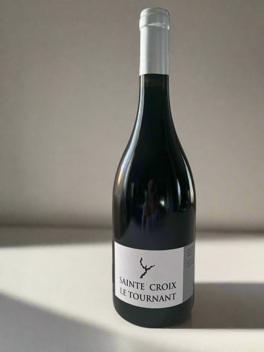 Bottle of Domaine Sainte Croix Le Tournant 2019 Syrah wine, featuring a minimalist label, placed on a neutral background.