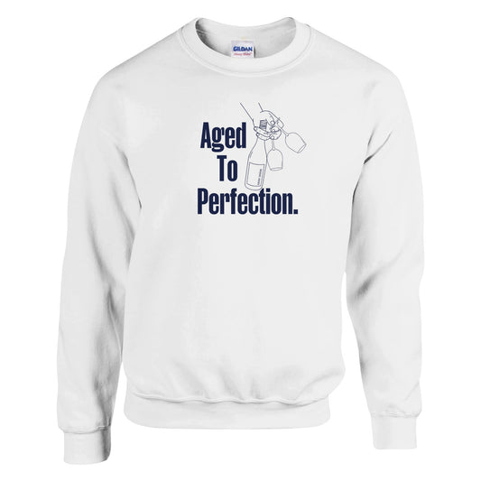 White oversized sweatshirt with 'Aged to Perfection' navy text design, perfect for wine lovers and milestone celebrations. Soft, cozy, and stylish.