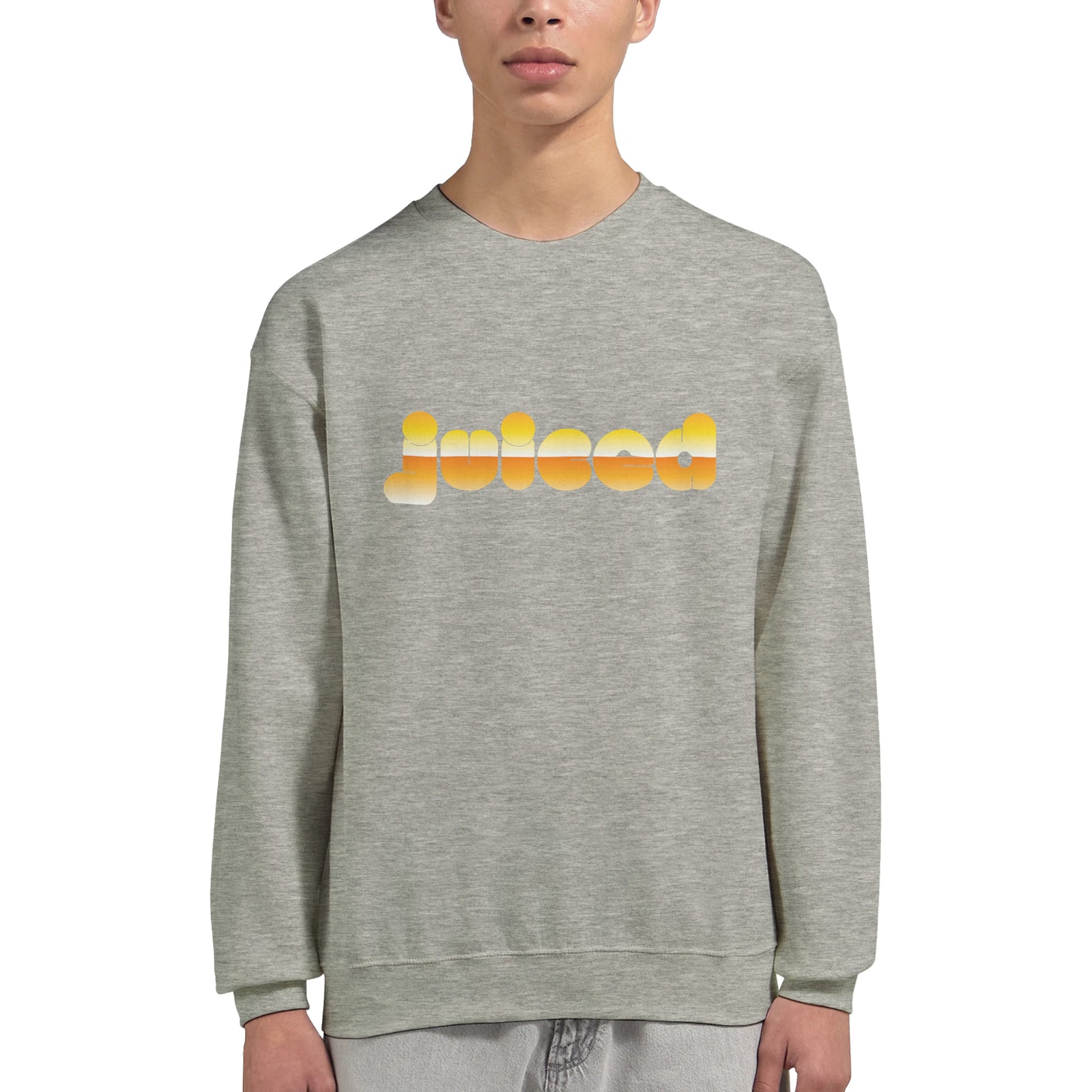 Model wearing Juiced sweatshirt by Taste Union — unisex grey crewneck with yellow text design inspired by natural wine and slow living, photographed on white background.