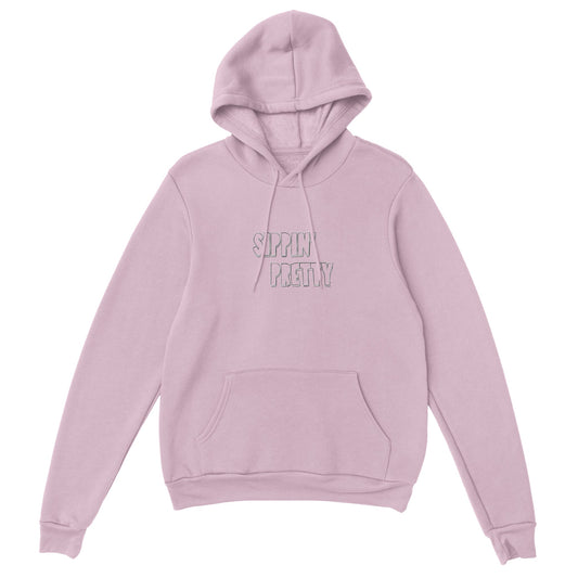 Pink hoodie with white embroidered text ‘Sippin’ Pretty’. Sustainable unisex hoodie by Taste Union with relaxed oversized fit.