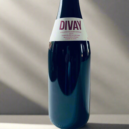 Bottle of Divay Rouge 2020 organic Grenache Noir wine, produced by Léah Anglès, displayed with its label showcasing its biodynamic roots from Collioure, Roussillon.