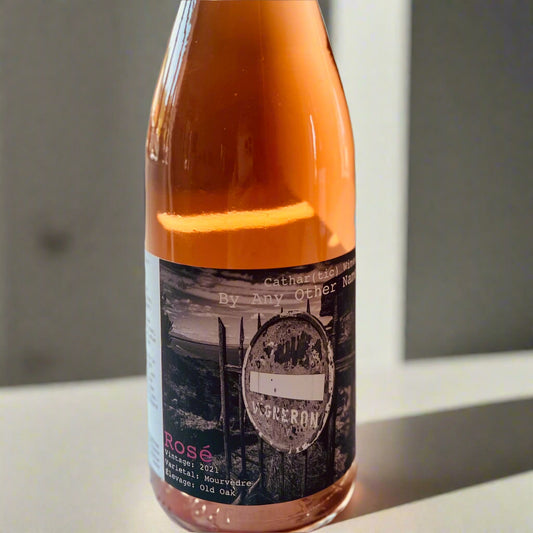 A bottle of Cathar(tic) By Any Other Name 2021 Rosé by Richard Bray, featuring a bold and artistic label design. The wine’s warm, pink hue is highlighted against a soft background, emphasising its elegance and character.