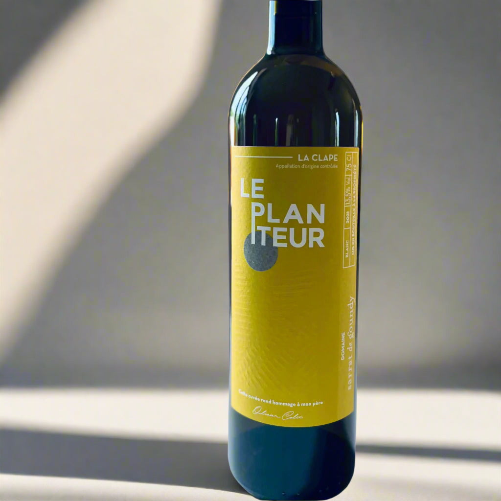 Bottle of Sarrat de Goundy Le Planteur 2021 white wine, showcasing a vibrant yellow label with modern typography, photographed on a light background.